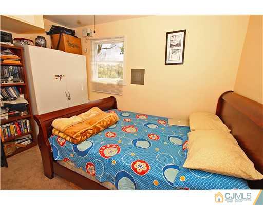 19 New Road Kendall Park, NJ 08824 - Photo 19 of 21 a bedroom with a bed and a wall painting
