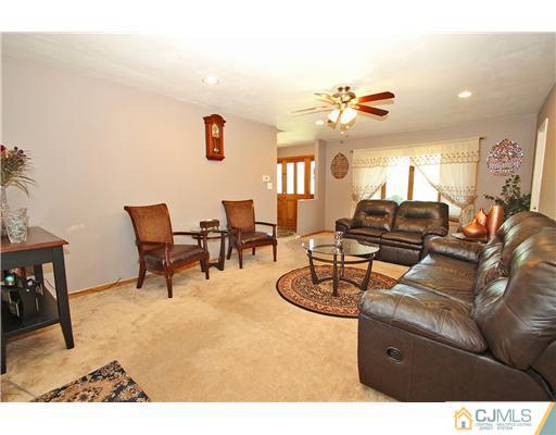 19 New Road Kendall Park, NJ 08824 - Photo 4 of 21 a living room with furniture and a chandelier