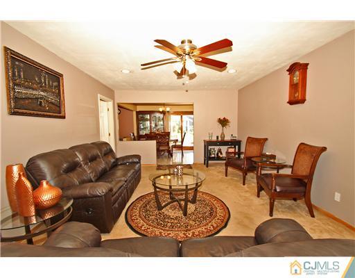 19 New Road Kendall Park, NJ 08824 - Photo 6 of 21 a living room with furniture a rug and a window