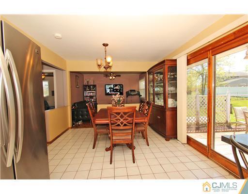 19 New Road Kendall Park, NJ 08824 - Photo 7 of 21 a dining room with furniture and a floor to ceiling window