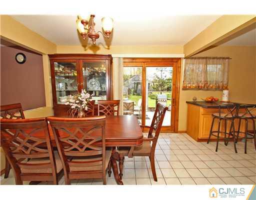 19 New Road Kendall Park, NJ 08824 - Photo 8 of 21 a view of a dining room with furniture large windows and wooden floor