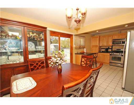 19 New Road Kendall Park, NJ 08824 - Photo 9 of 21 a view of a dining room with furniture water view and a chandelier