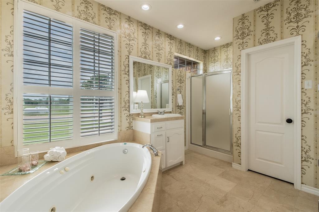 13507 Friendship Road Pilot Point, TX 76258 - Photo 15 of 39 a bathroom with a bathtub and a sink