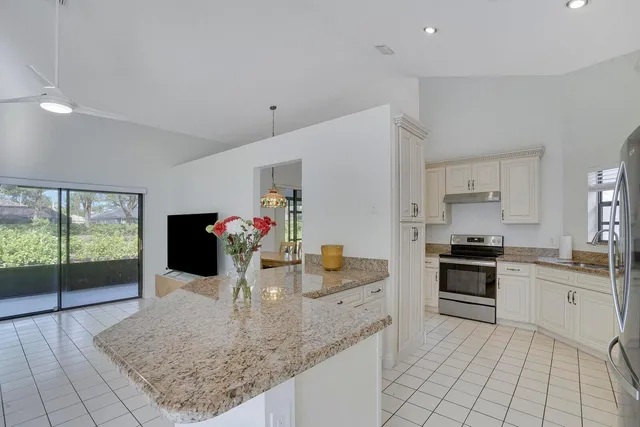 a kitchen with granite countertop a sink and cabinets