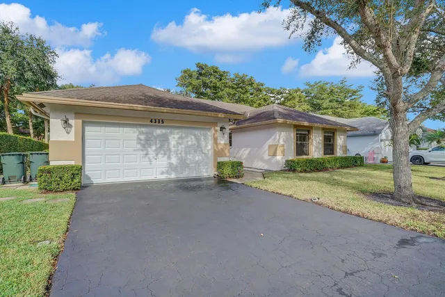 a view of a house with a yard and garage