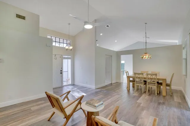 a view of a dining room with furniture wooden floor and chandelier
