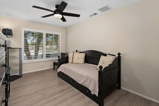a bedroom with a bed and a large window