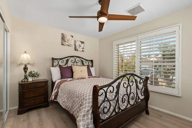 a bedroom with a bed and a window