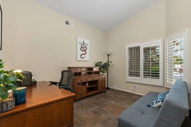 a bedroom with furniture and a window