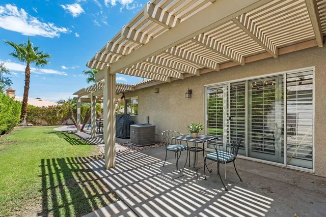 a view of a patio with table and chairs and potted plants
