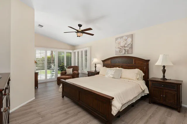 a bedroom with a large bed and a window