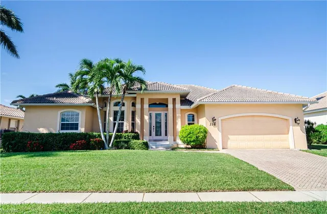 a front view of a house with garden
