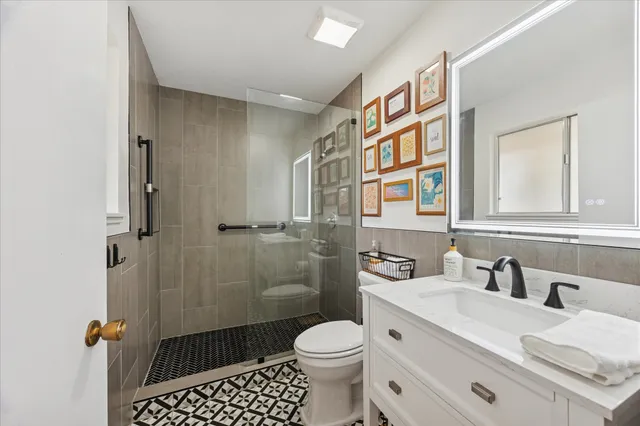 a bathroom with a sink toilet and shower