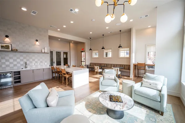 a hallway with wooden floor and windows