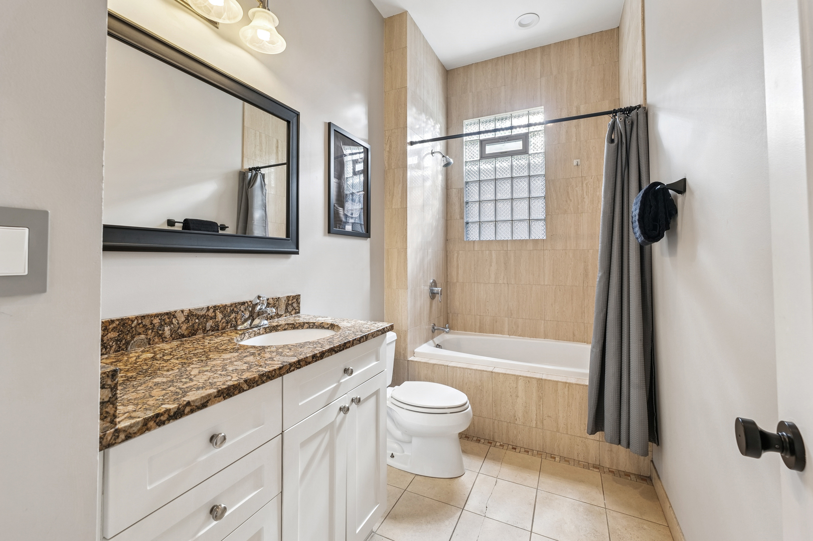 4038 West Addison Street Chicago, IL 60641 - Photo 12 of 33 a bathroom with a granite countertop sink toilet and shower