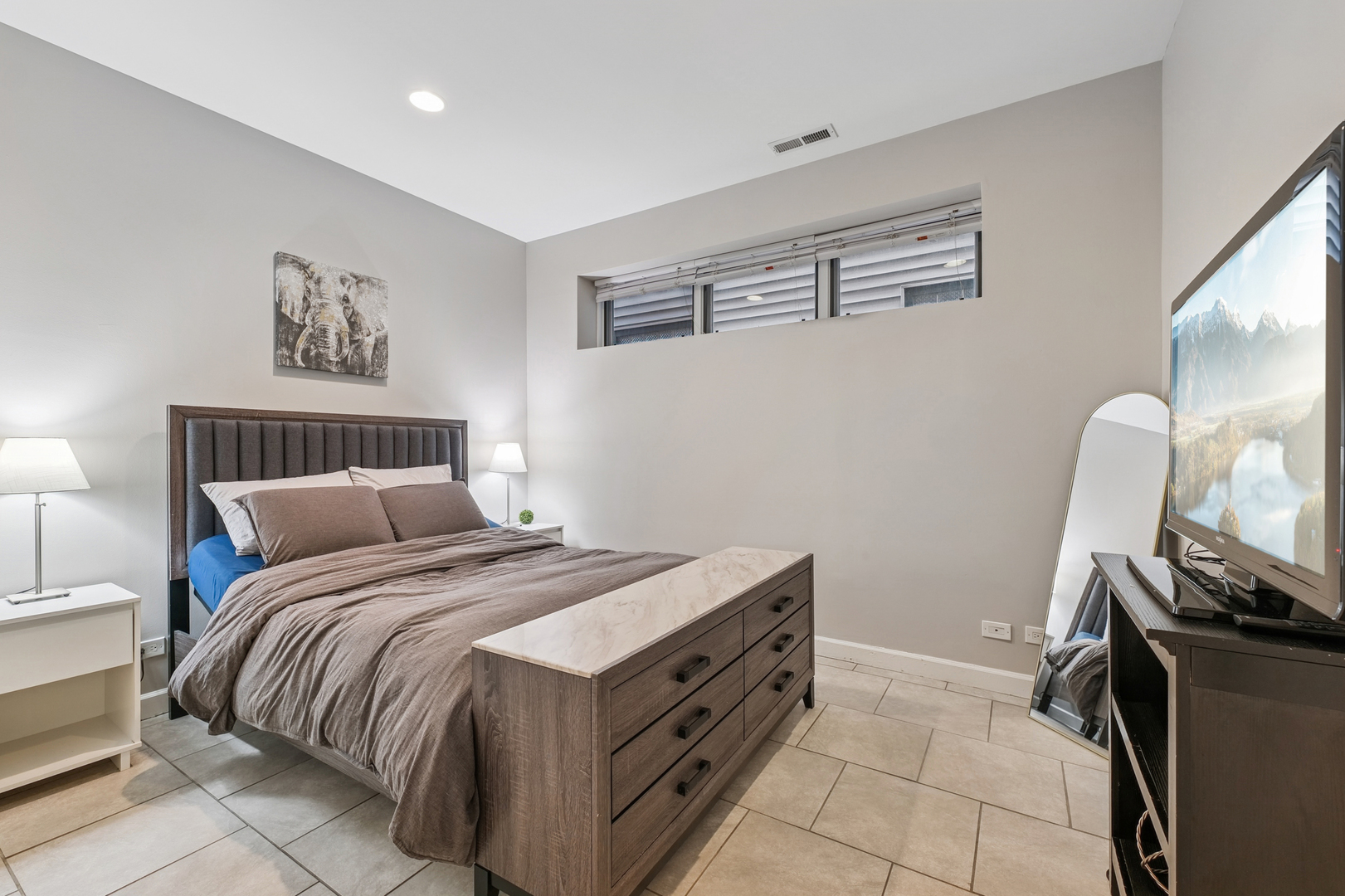 4038 West Addison Street Chicago, IL 60641 - Photo 23 of 33 a bedroom with a bed and a flat screen tv