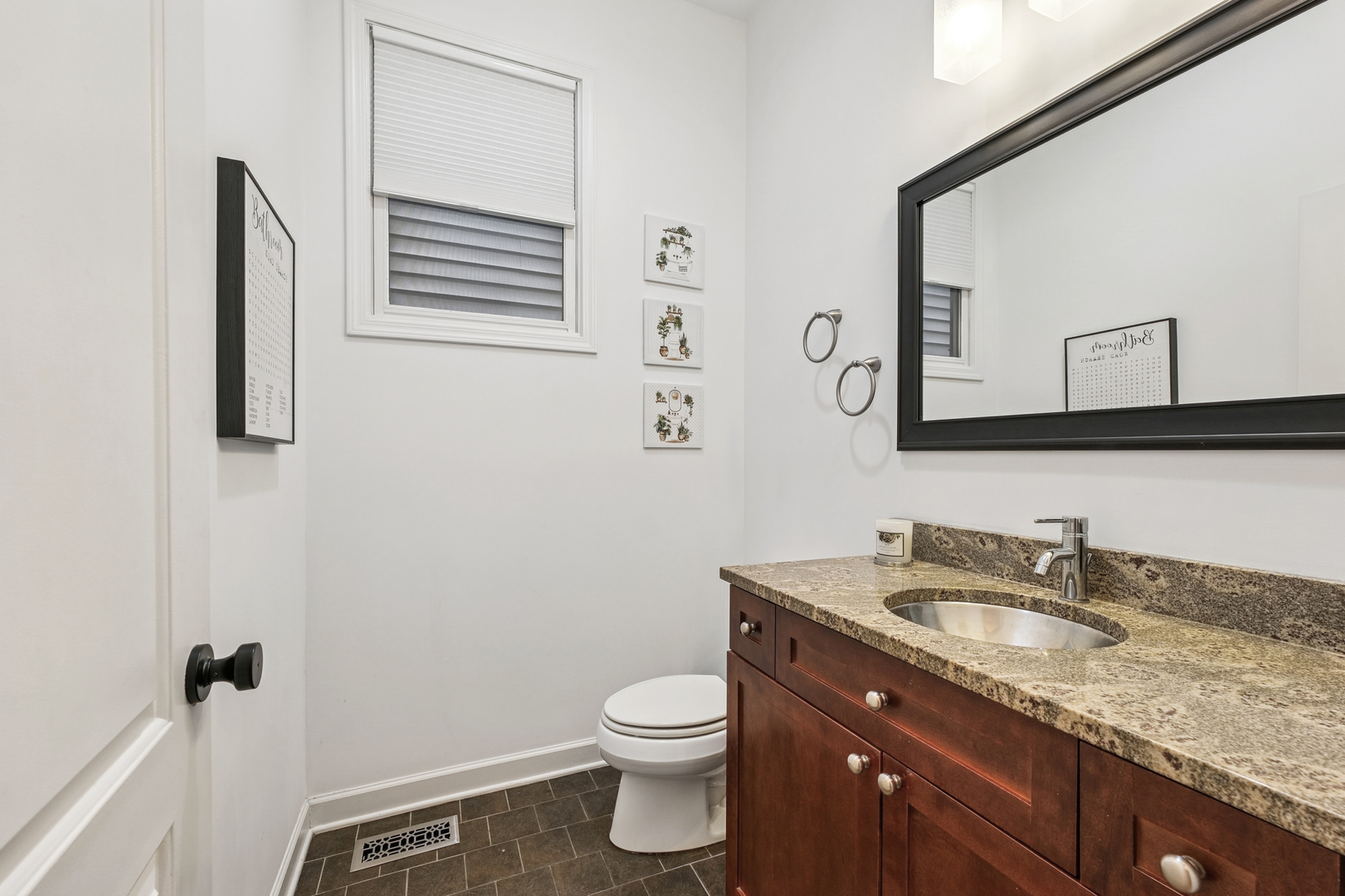 4038 West Addison Street Chicago, IL 60641 - Photo 9 of 33 a bathroom with a granite countertop toilet sink and mirror