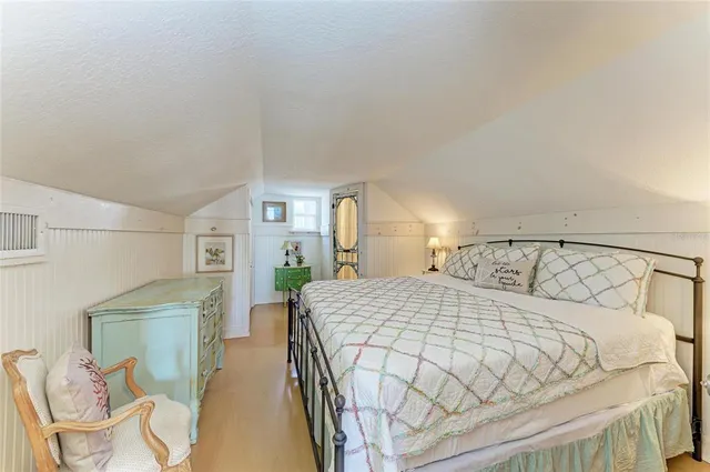 a bedroom with a bed and chair