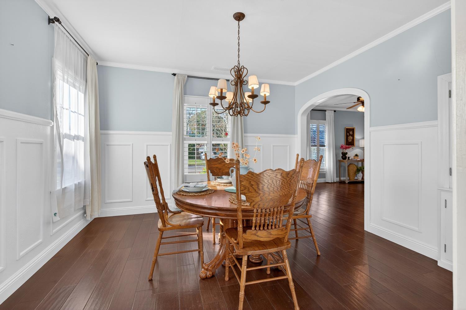 2644 Crafton Way Stockton, CA 95204 - Photo 15 of 50 a dining room with furniture wooden floor potted plants and a chandelier