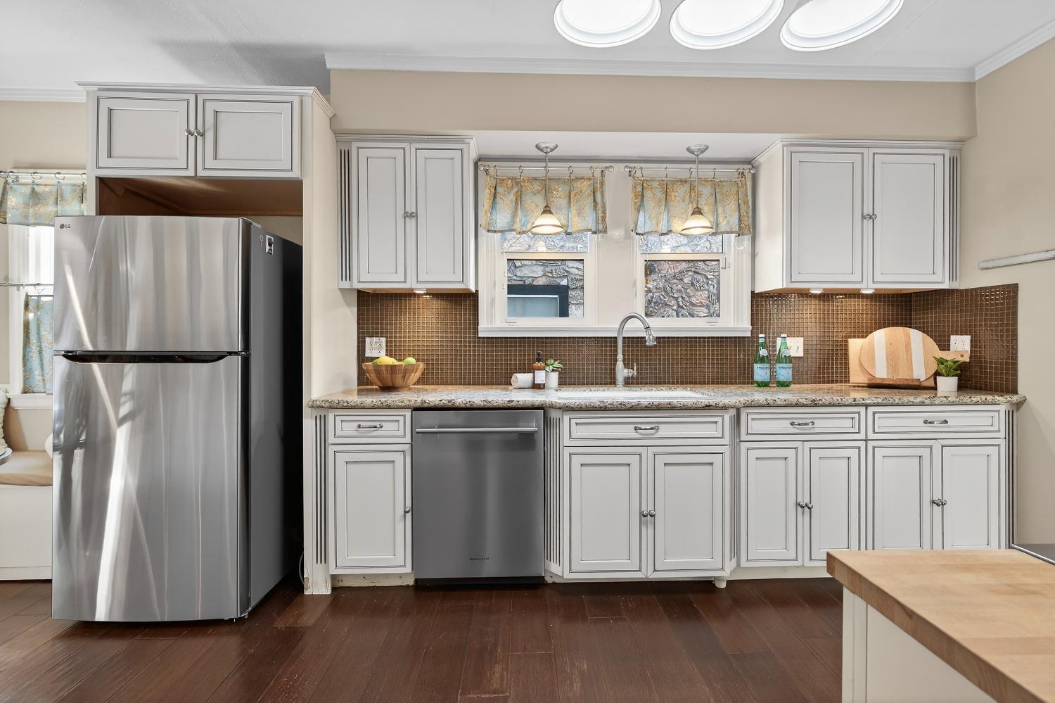 2644 Crafton Way Stockton, CA 95204 - Photo 17 of 50 a kitchen with granite countertop a refrigerator a sink and white cabinets