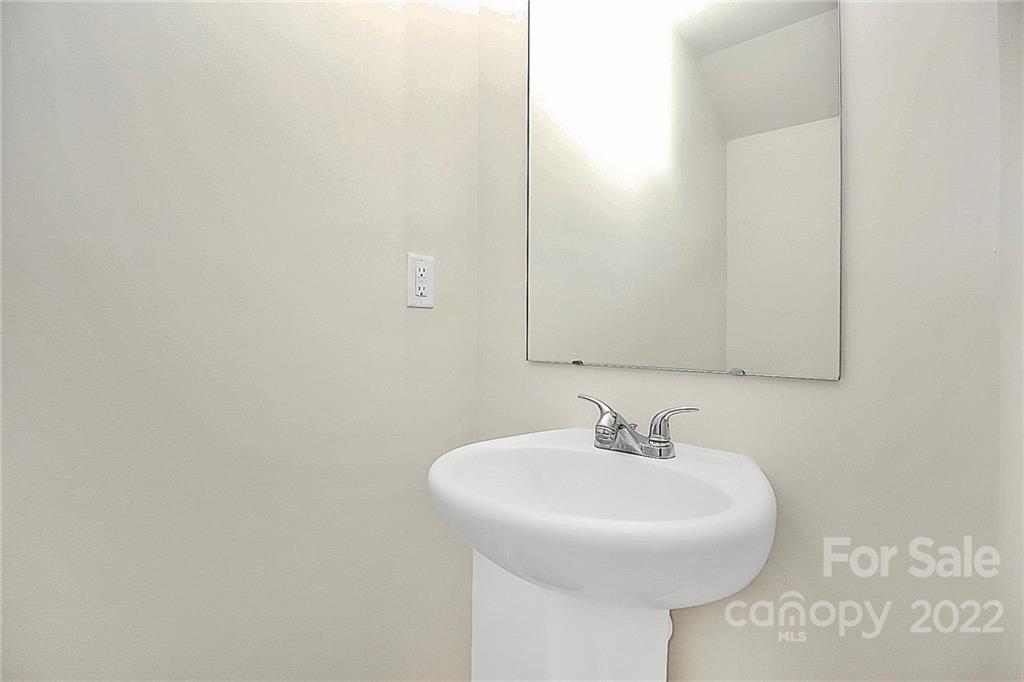 8729 Pence Road Charlotte, NC 28215 - Photo 12 of 26 a bathroom with a sink and a mirror