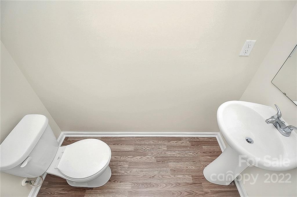 8729 Pence Road Charlotte, NC 28215 - Photo 13 of 26 a bathroom with a toilet sink and mirror