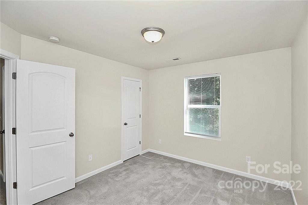 8729 Pence Road Charlotte, NC 28215 - Photo 18 of 26 a view of an empty room with a window