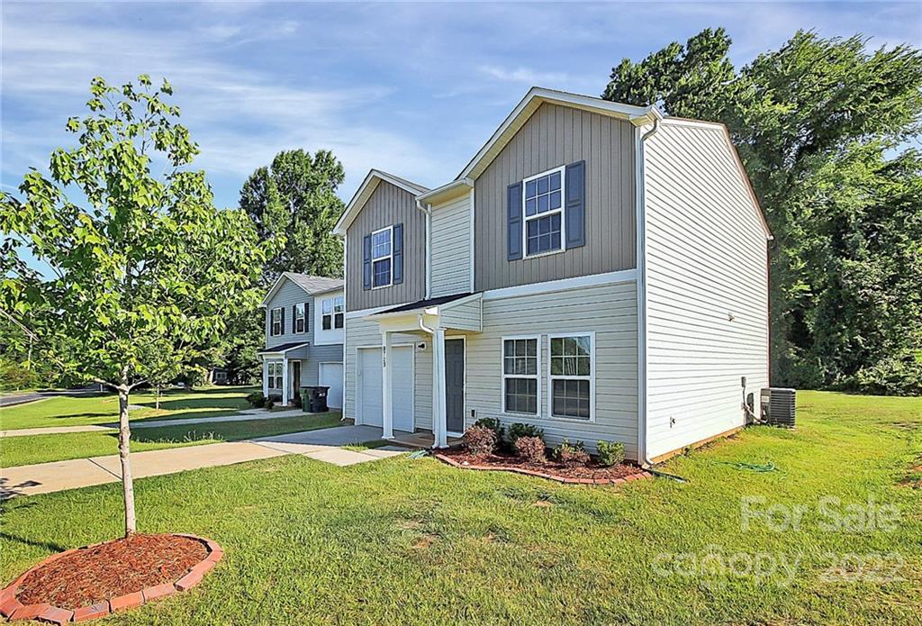 8729 Pence Road Charlotte, NC 28215 - Photo 2 of 26 a view of a house with backyard and a tree