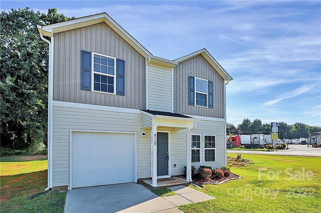 8729 Pence Road Charlotte, NC 28215 - Photo 3 of 26 a view of a house with swimming pool and a yard