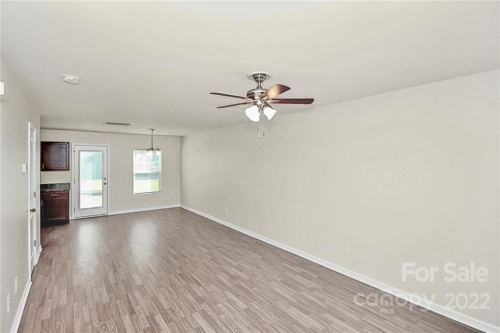 8729 Pence Road Charlotte, NC 28215 - Photo 6 of 26 wooden floor in an empty room with a window