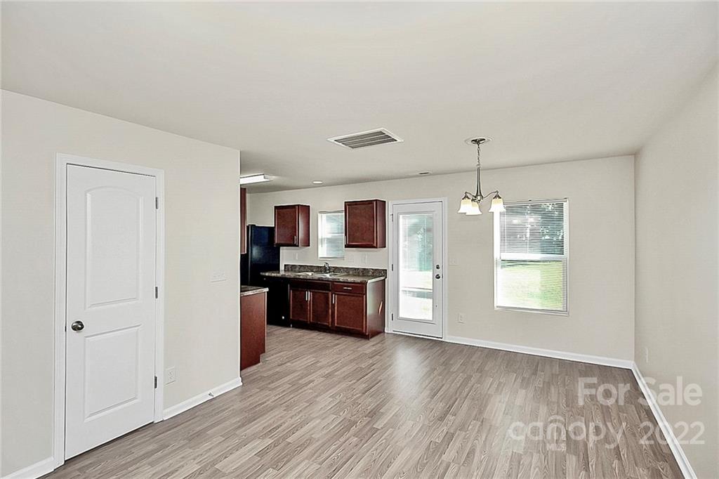 8729 Pence Road Charlotte, NC 28215 - Photo 7 of 26 wooden floor and dining room with furniture wooden floor and window
