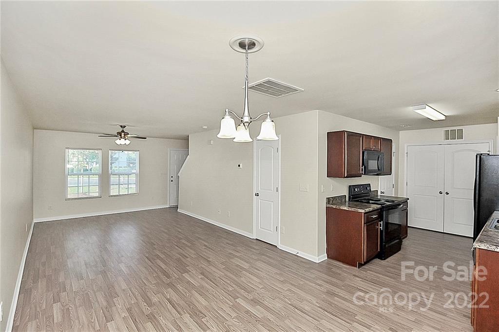 8729 Pence Road Charlotte, NC 28215 - Photo 8 of 26 a kitchen with stainless steel appliances granite countertop a stove and a refrigerator