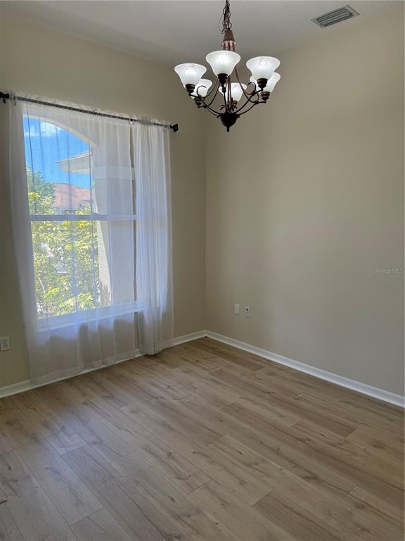 4833 Post Pointe Drive Sarasota, FL 34233 - Photo 12 of 29 an empty room with wooden floor and windows