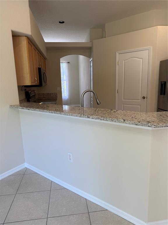 4833 Post Pointe Drive Sarasota, FL 34233 - Photo 14 of 29 a bathroom with a granite countertop sink and a mirror