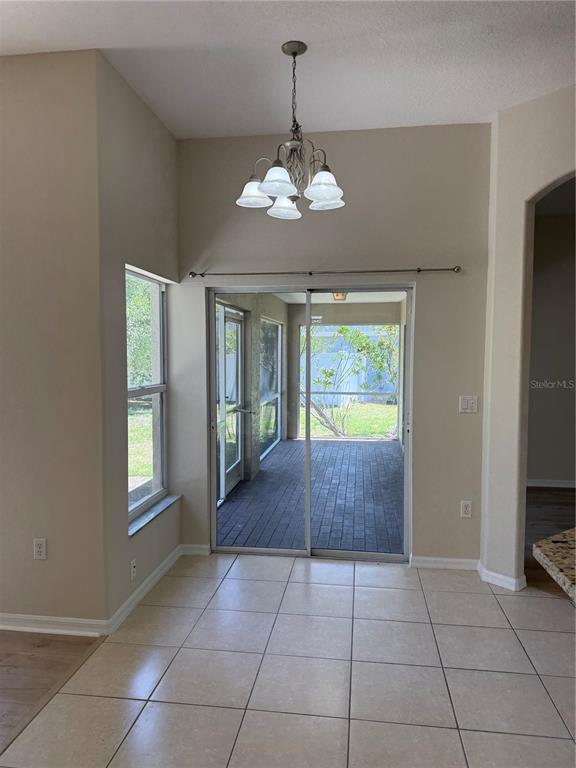 4833 Post Pointe Drive Sarasota, FL 34233 - Photo 15 of 29 a view of an entryway with a chandelier