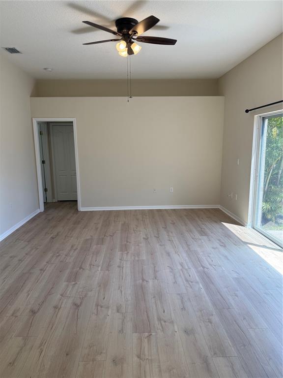 4833 Post Pointe Drive Sarasota, FL 34233 - Photo 16 of 29 a view of an empty room with wooden floor and a window