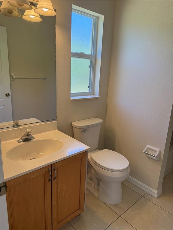 4833 Post Pointe Drive Sarasota, FL 34233 - Photo 20 of 29 a bathroom with a sink toilet and vanity