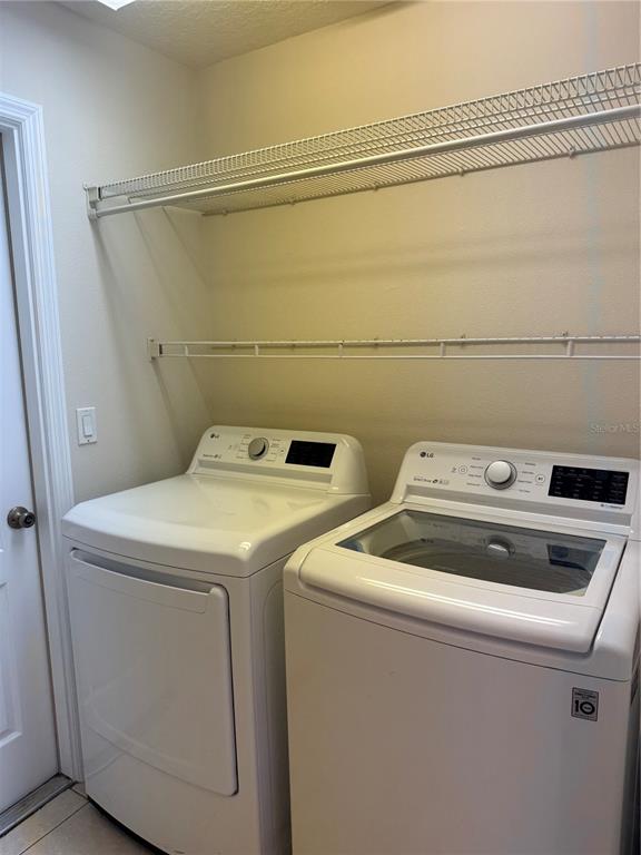 4833 Post Pointe Drive Sarasota, FL 34233 - Photo 28 of 29 a utility room with dryer and washer