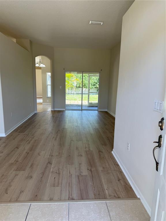 4833 Post Pointe Drive Sarasota, FL 34233 - Photo 3 of 29 wooden floor in an empty room with a window