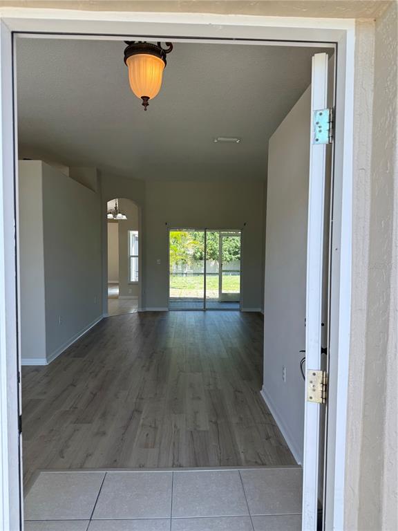 4833 Post Pointe Drive Sarasota, FL 34233 - Photo 4 of 29 a view of a room with wooden floor and a window