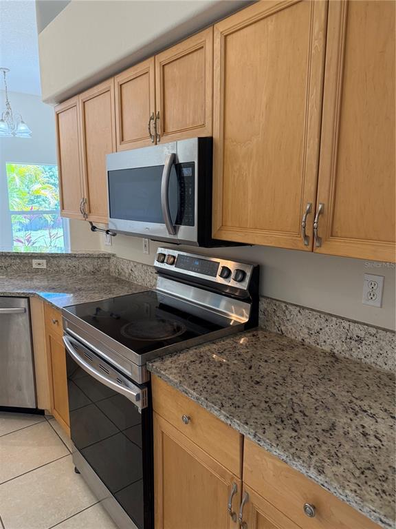 4833 Post Pointe Drive Sarasota, FL 34233 - Photo 6 of 29 a kitchen with a stove and a microwave