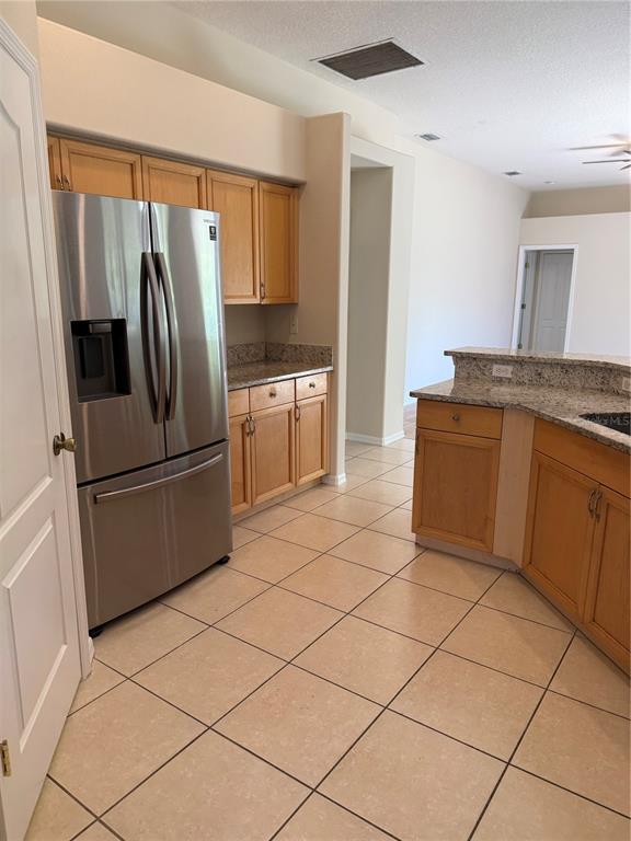4833 Post Pointe Drive Sarasota, FL 34233 - Photo 8 of 29 a kitchen with stainless steel appliances a refrigerator sink and cabinets