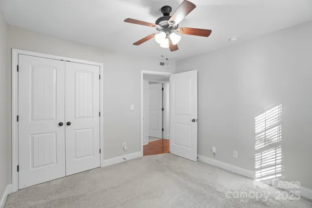 a bathroom with a granite countertop sink mirror vanity and toilet