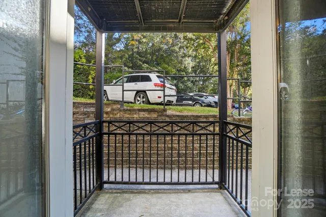 a view of a balcony with furniture and wooden floor