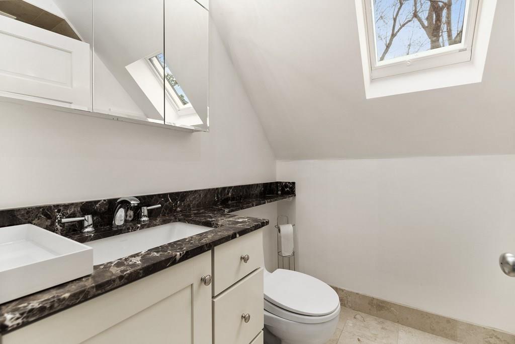28 Balcarres Road Newton, MA 02465 - Photo 18 of 21 a bathroom with a granite countertop sink mirror vanity and toilet