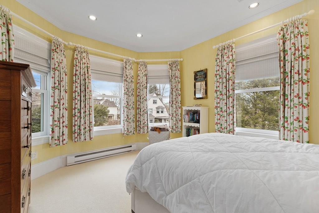 28 Balcarres Road Newton, MA 02465 - Photo 10 of 21 a spacious bedroom with a large window and a chandelier