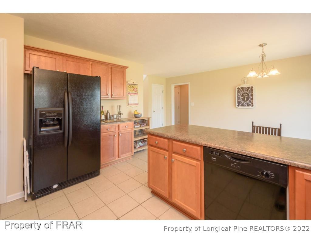 11 Lattimore Road Cameron, NC 28326 - Photo 11 of 28 a kitchen with stainless steel appliances granite countertop a refrigerator and a sink