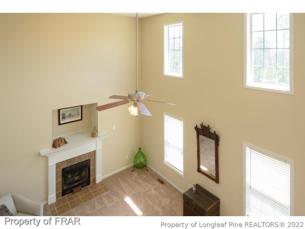 11 Lattimore Road Cameron, NC 28326 - Photo 15 of 28 a living room with a fireplace furniture and a window