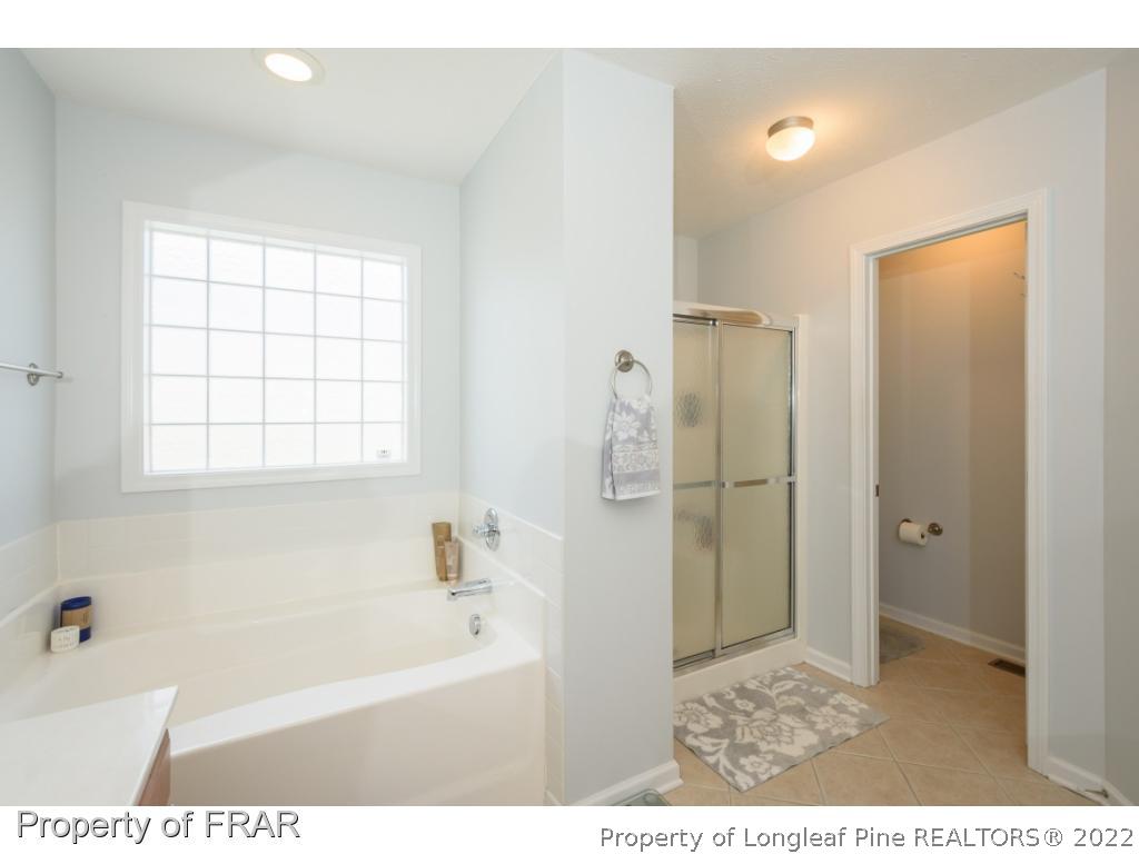 11 Lattimore Road Cameron, NC 28326 - Photo 18 of 28 a bathroom with a bathtub and a shower