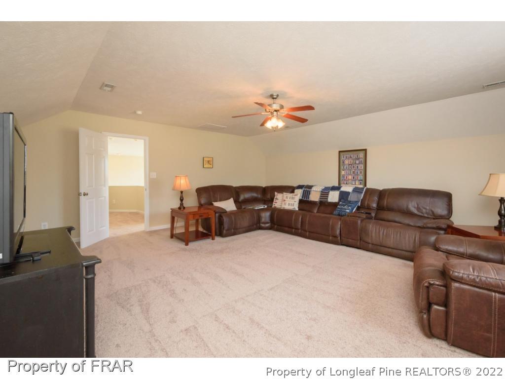 11 Lattimore Road Cameron, NC 28326 - Photo 24 of 28 a living room with furniture a flat screen tv and dresser